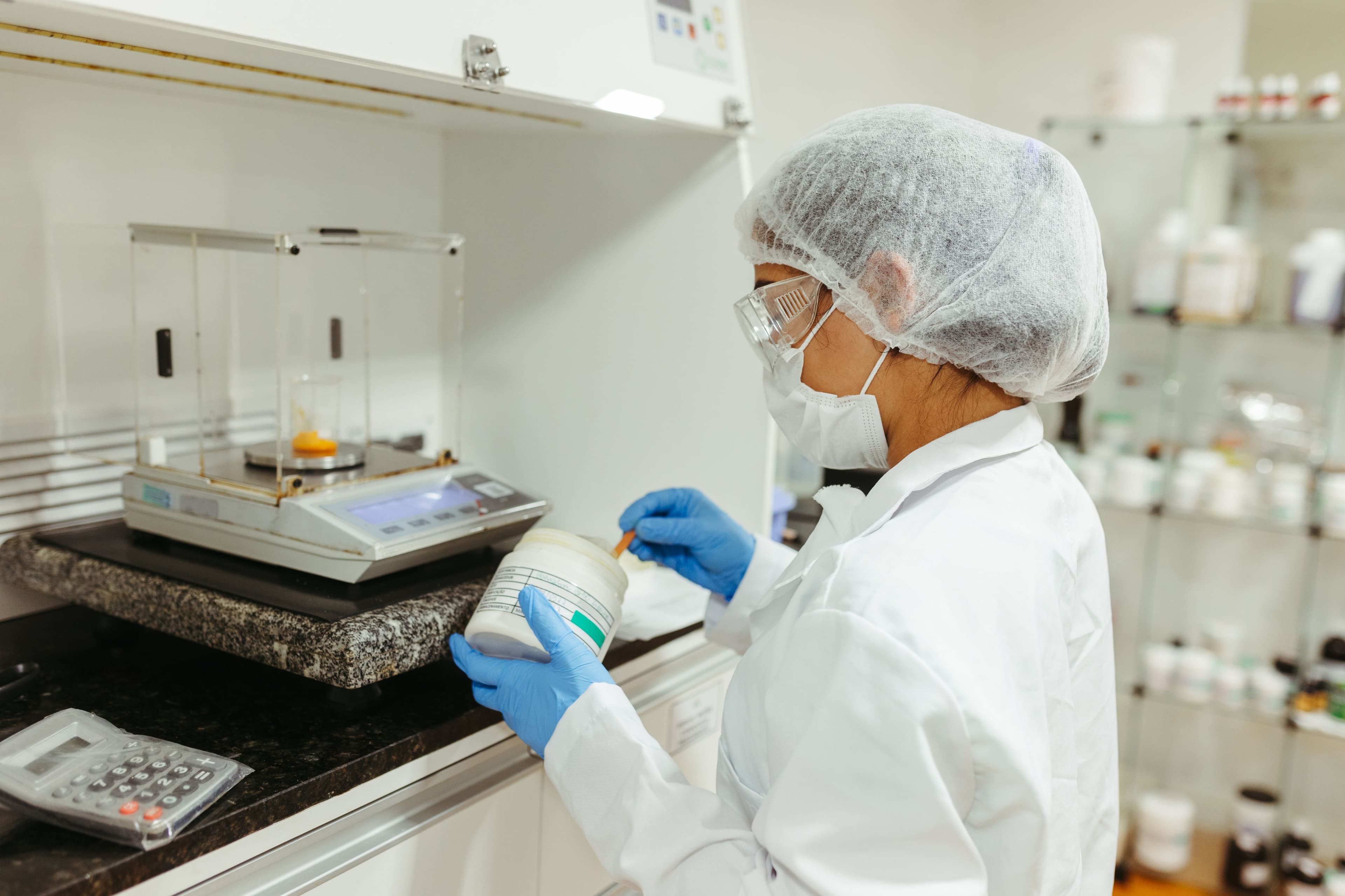 Healthcare worker preparing a sample in a laboratory.